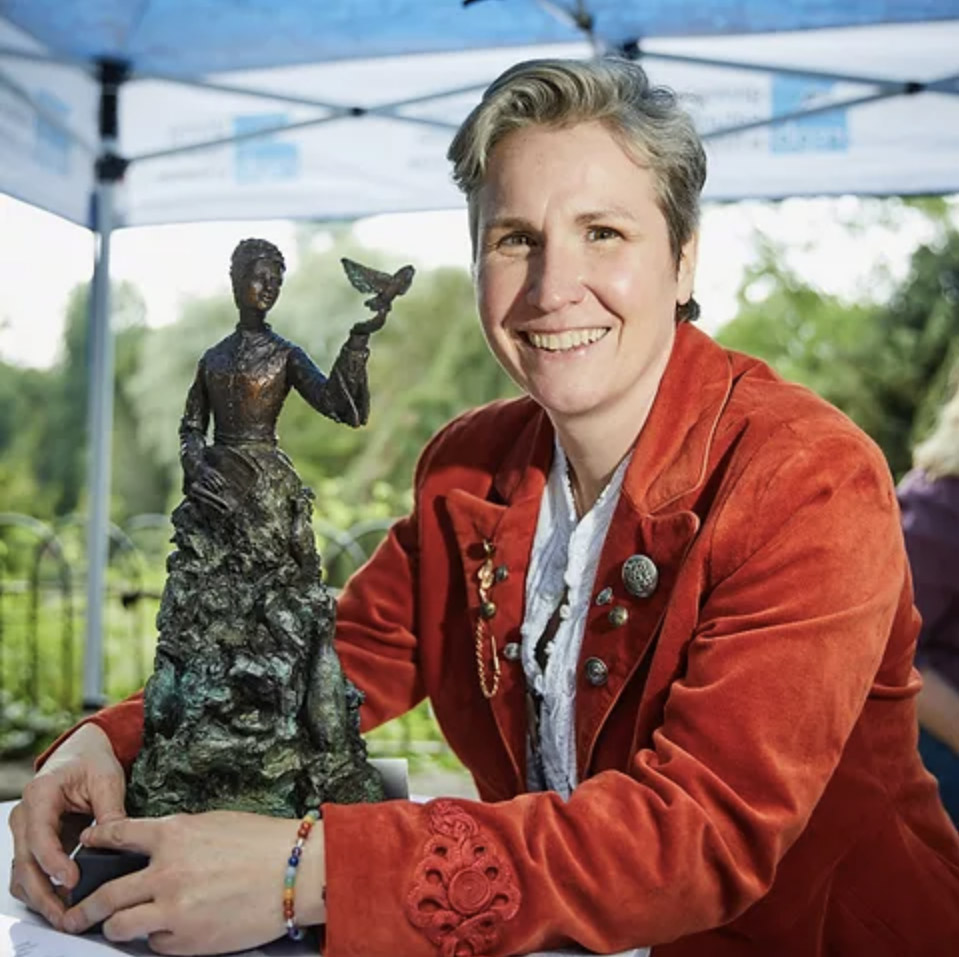 Eve with small statuette of Emily Williamson in Fletcher Moss Park